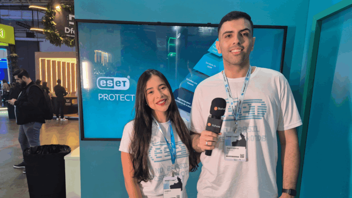 ESET: Danielle Novais e Thales Santos, em entrevista ao Itshow no Mind The Sec 2025, diante do estande da empresa.